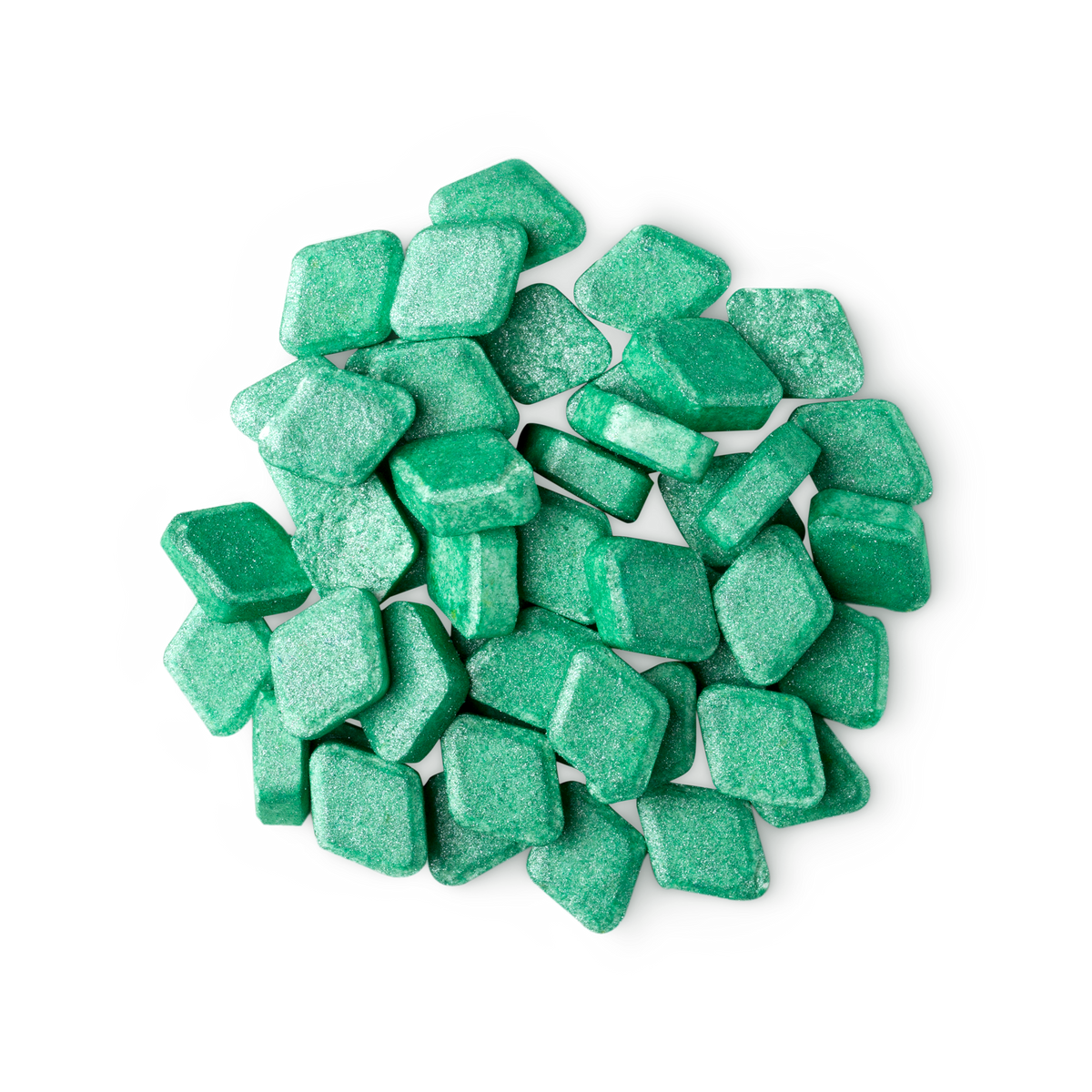 A pile of small, diamond-shaped, green Crème De Menthe mouthwash tabs shot from above.